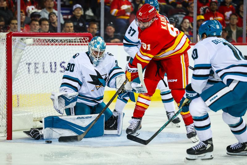 Nov 13, 2025; Calgary, Alberta, CAN; San Jose Sharks goaltender Yaroslav Askarov (30) makes a save against Calgary Flames center Nazem Kadri (91) during the second period at Scotiabank Saddledome. Mandatory Credit: Sergei Belski-Imagn Images