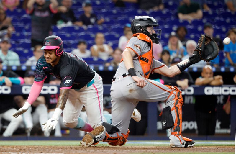 May 31, 2025; Miami, Florida, USA;  Miami Marlins center fielder Dane Myers (54) scores behind San Francisco Giants catcher Patrick Bailey (14) during the second inning at loanDepot Park. Mandatory Credit: Rhona Wise-Imagn Images