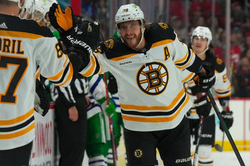 Mar 26, 2023; Raleigh, North Carolina, USA;  Boston Bruins right wing David Pastrnak (88) celebrates his goal against the Carolina Hurricanes during the first period at PNC Arena. Mandatory Credit: James Guillory-USA TODAY Sports