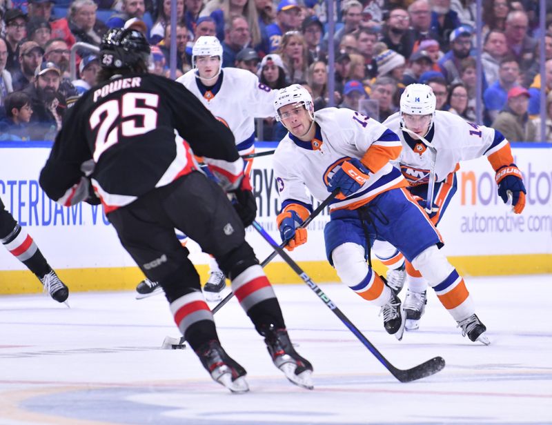 Oct 21, 2023; Buffalo, New York, USA; New York Islanders center Mathew Barzal (13) tries to get the puck past Buffalo Sabres defenseman Owen Power (25) in the third period  at KeyBank Center. Mandatory Credit: Mark Konezny-USA TODAY Sports