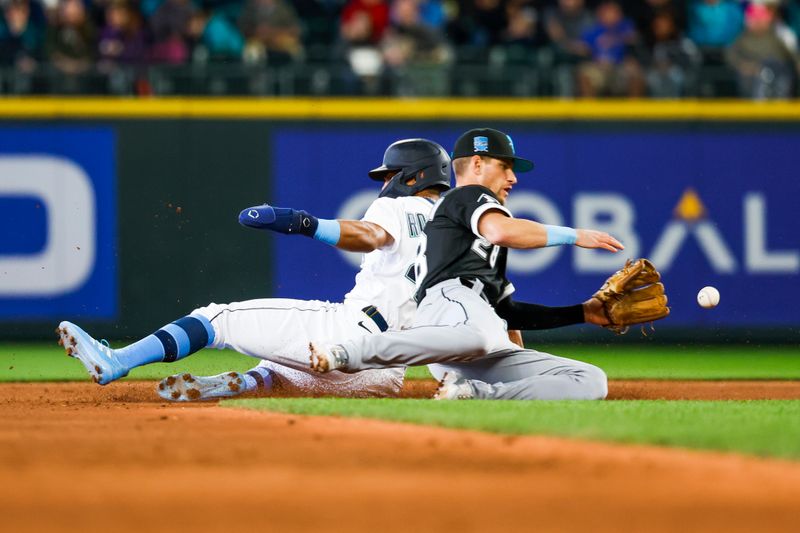 Jun 18, 2023; Seattle, Washington, USA; Seattle Mariners center fielder Julio Rodriguez (44) slides to steal a base before Chicago White Sox second baseman Zach Remillard (28) can receive a throw during the sixth inning at T-Mobile Park. Mandatory Credit: Joe Nicholson-USA TODAY Sports