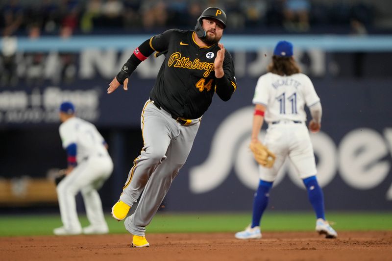 Jun 2, 2024; Toronto, Ontario, CAN; Pittsburgh Pirates first baseman Rowdy Tellez (44) runs to third base on a ball hot by Pittsburgh Pirates center fielder Ji Hwan Bae (3) during the second inning against the Toronto Blue Jays at Rogers Centre. Mandatory Credit: John E. Sokolowski-USA TODAY Sports