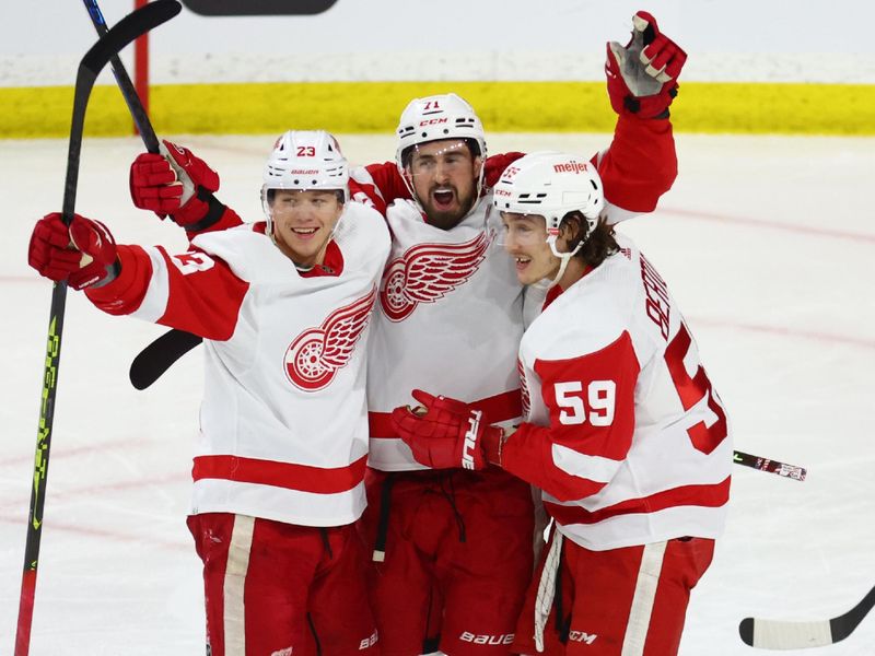 Jan 17, 2023; Tempe, Arizona, USA; Detroit Red Wings center Dylan Larkin (71) celebrates a goal with left wing Lucas Raymond (23) and Tyler Bertuzzi (59) against the Arizona Coyotes in the second period at Mullett Arena. Mandatory Credit: Mark J. Rebilas-USA TODAY Sports