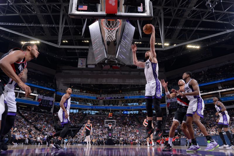 SACRAMENTO, CA - OCTOBER 13: Domantas Sabonis #11 of the Sacramento Kings rebounds the ball during the game against the Portland Trail Blazers during a NBA preseason game on October 13, 2024 at Golden 1 Center in Sacramento, California. NOTE TO USER: User expressly acknowledges and agrees that, by downloading and or using this Photograph, user is consenting to the terms and conditions of the Getty Images License Agreement. Mandatory Copyright Notice: Copyright 2024 NBAE (Photo by Rocky Widner/NBAE via Getty Images)