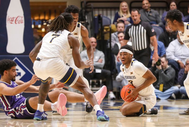 Feb 25, 2025; Morgantown, West Virginia, USA; West Virginia Mountaineers guard KJ Tenner (3) dives on a loose ball during the first half against the TCU Horned Frogs at WVU Coliseum. Mandatory Credit: Ben Queen-Imagn Images