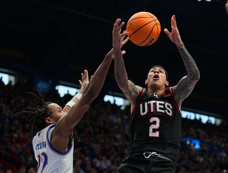 Feb 7, 2026; Lawrence, Kansas, USA; Kansas Jayhawks guard Corbin Allen (2) loses control of the ball while shooting against Kansas Jayhawks guard Darryn Peterson (22) during the first half at Allen Fieldhouse. Mandatory Credit: Jay Biggerstaff-Imagn Images
