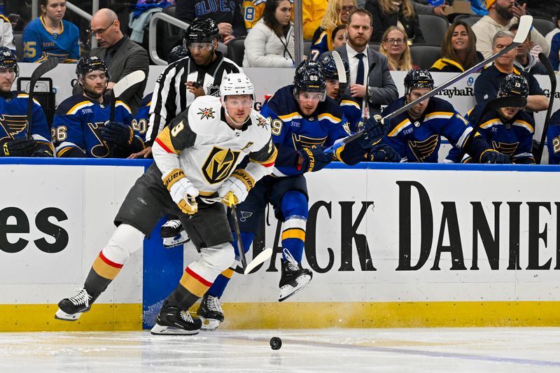 Mar 25, 2024; St. Louis, Missouri, USA;  Vegas Golden Knights center Jack Eichel (9) and St. Louis Blues center Robert Thomas (18) battle for the puck during the third period at Enterprise Center. Mandatory Credit: Jeff Curry-USA TODAY Sports