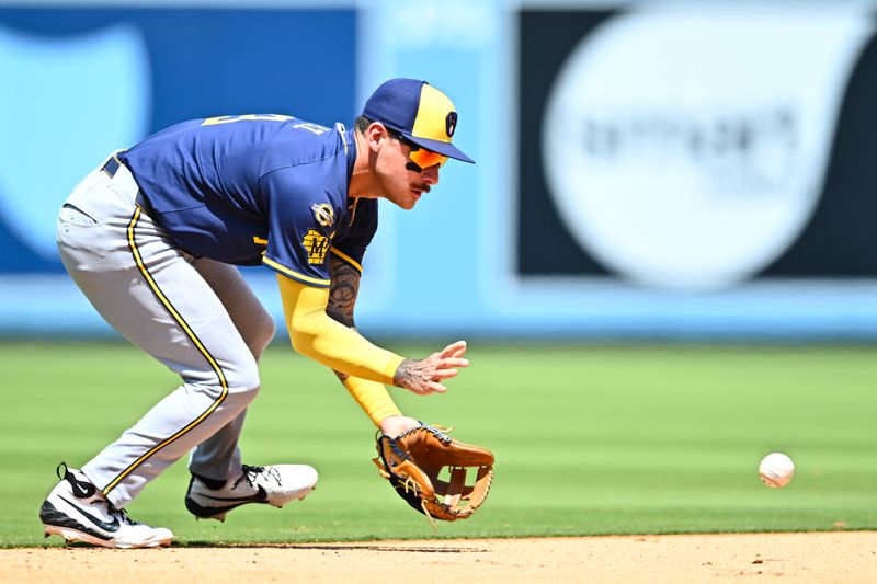 Jul 20, 2025; Los Angeles, California, USA; Milwaukee Brewers shortstop Joey Ortiz (3) fields a ball against the Los Angeles Dodgers during the fifth inning at Dodger Stadium. Mandatory Credit: Jonathan Hui-Imagn Images