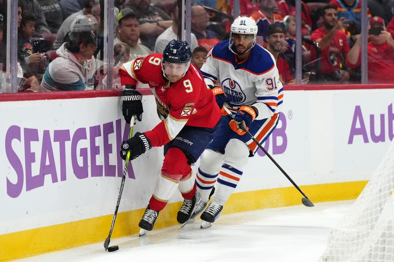 Nov 20, 2023; Sunrise, Florida, USA; Florida Panthers center Sam Bennett (9) controls the puck away from Edmonton Oilers left wing Evander Kane (91) during the second period at Amerant Bank Arena. Mandatory Credit: Jasen Vinlove-USA TODAY Sports