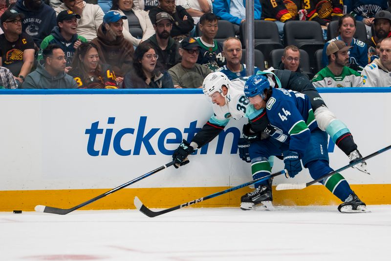 Sep 26, 2025; Vancouver, British Columbia, CAN;  Vancouver Canucks forward Kiefer Sherwood (44) checks Seattle Kraken forward Jani Nyman (38) in the second period at Rogers Arena. Mandatory Credit: Bob Frid-Imagn Images