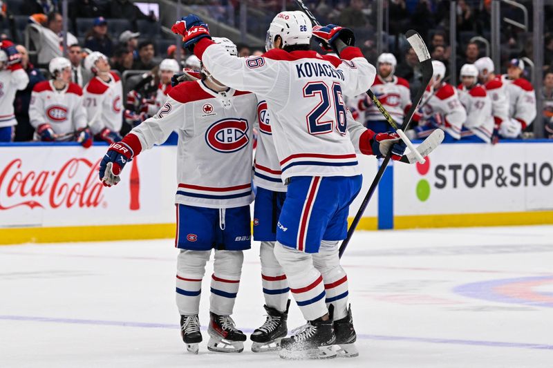 Apr 11, 2024; Elmont, New York, USA; Montreal Canadiens defenseman Jordan Harris (54) celebrates his goal with aa26 and Montreal Canadiens right wing Cole Caufield (22) against the New York Islanders during the first period at UBS Arena. Mandatory Credit: Dennis Schneidler-USA TODAY Sports