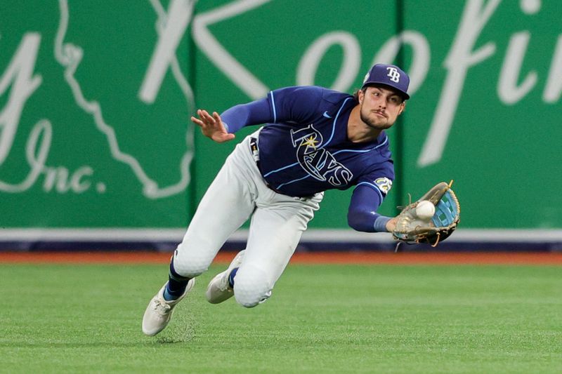    Sep 7, 2023; St. Petersburg, Florida, USA;  Tampa Bay Rays right fielder Josh Lowe (15) make a diving catch against the Seattle Mariners in the fifth inning at Tropicana Field. Mandatory Credit: Nathan Ray Seebeck-USA TODAY Sports