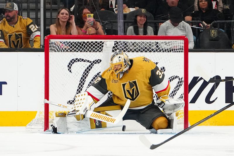 Apr 10, 2025; Las Vegas, Nevada, USA; Vegas Golden Knights goaltender Adin Hill (33) makes a save against the Seattle Kraken during the second period at T-Mobile Arena. Mandatory Credit: Stephen R. Sylvanie-Imagn Images