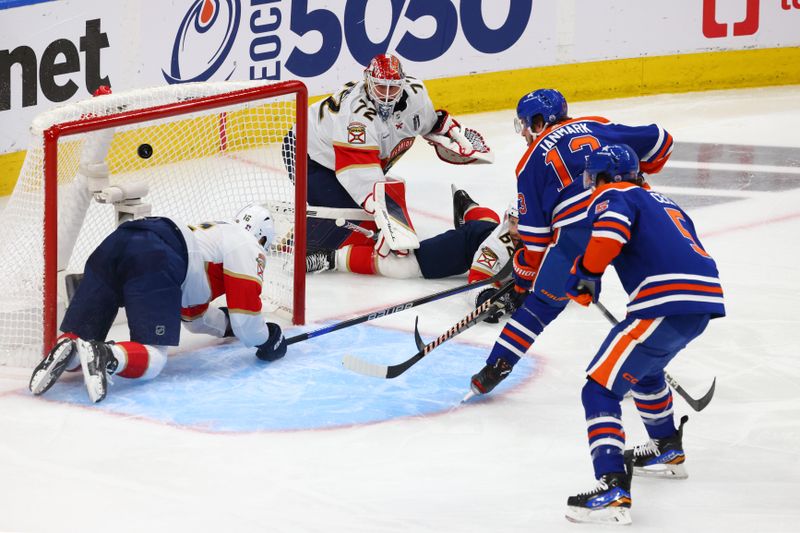 Jun 15, 2024; Edmonton, Alberta, CAN; Edmonton Oilers center Mattias Janmark (13) scores a goal passed Florida Panthers center Aleksander Barkov (16) in the first period in game four of the 2024 Stanley Cup Final at Rogers Place. Mandatory Credit: Sergei Belski-USA TODAY Sports