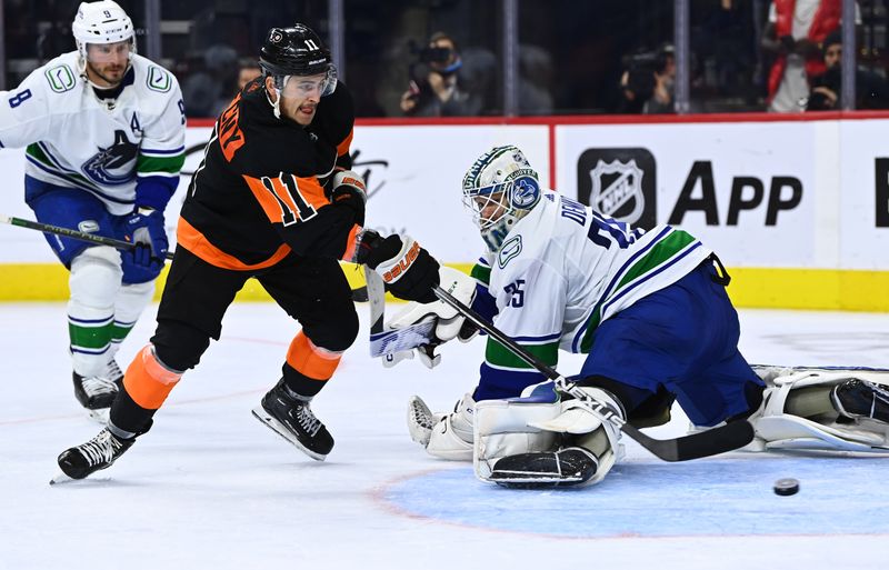 Oct 15, 2022; Philadelphia, Pennsylvania, USA; Philadelphia Flyers right wing Travis Konecny (11) scores a goal past Vancouver Canucks goalie Thatcher Demko (35) in the third period at Wells Fargo Center. Mandatory Credit: Kyle Ross-USA TODAY Sports