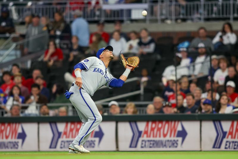 Sep 27, 2024; Atlanta, Georgia, USA; Kansas City Royals first baseman Yuli Gurriel (18) catches a pop fly against the Atlanta Braves in the second inning at Truist Park. Mandatory Credit: Brett Davis-Imagn Images