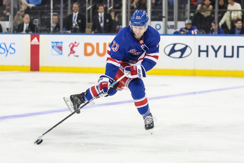 Sep 26, 2023; New York, New York, USA;  New York Rangers defenseman Adam Fox (23) controls the puck in the third period against the New York Islanders at Madison Square Garden. Mandatory Credit: Wendell Cruz-USA TODAY Sports