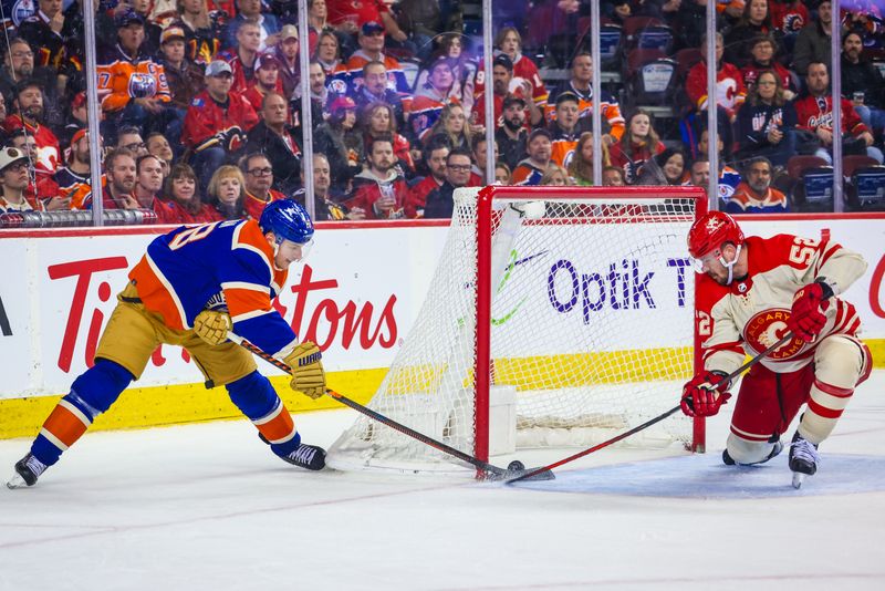 Jan 20, 2024; Calgary, Alberta, CAN; Edmonton Oilers left wing Zach Hyman (18) scores a goal as Calgary Flames defenseman MacKenzie Weegar (52) defends during the third period at Scotiabank Saddledome. Mandatory Credit: Sergei Belski-USA TODAY Sports