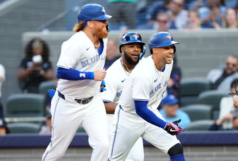 Jun 27, 2024; Toronto, Ontario, CAN; Toronto Blue Jays right fielder George Springer (right), designated hitter Justin Turner (2) and first baseman Vladimir Guerrero Jr. (center) celebrate at home plate after they scored on Springer's home run against the New York Yankees during the first inning at Rogers Centre. Mandatory Credit: John E. Sokolowski-USA TODAY Sports