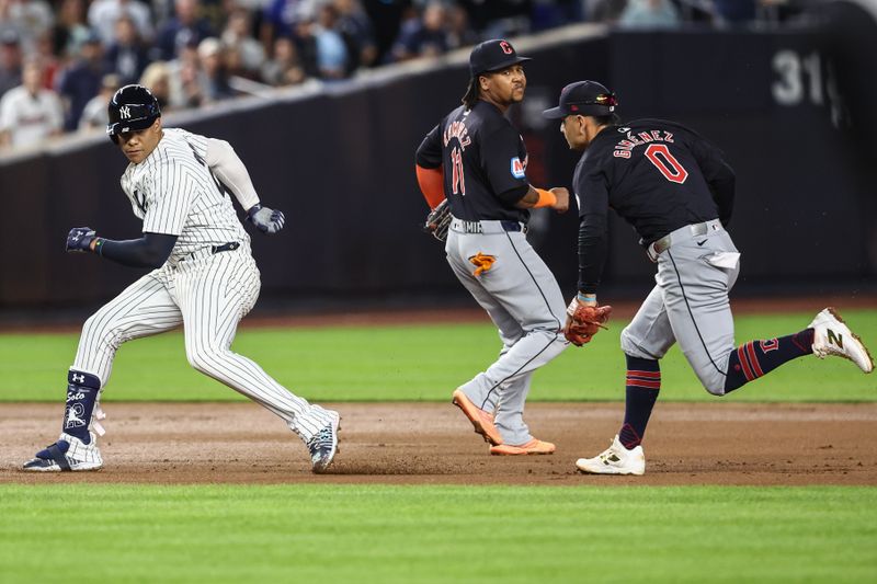 Aug 21, 2024; Bronx, New York, USA;  Cleveland Guardians second baseman Andrés Giménez (0) chases New York Yankees right fielder Juan Soto (22) during a run-down in the fourth inning at Yankee Stadium. Mandatory Credit: Wendell Cruz-USA TODAY Sports