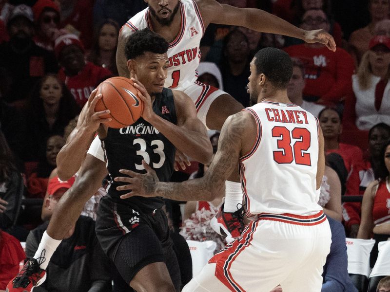 Jan 28, 2023; Houston, Texas, USA; Cincinnati Bearcats forward Ody Oguama (33) is guarded by Houston Cougars forward Reggie Chaney (32) and guard Jamal Shead (1) in the first half at Fertitta Center. Mandatory Credit: Thomas Shea-USA TODAY Sports