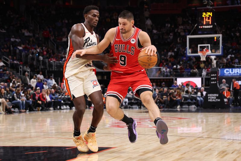 DETROIT, MICHIGAN - NOVEMBER 18: Nikola Vucevic #9 of the Chicago Bulls tries to get around Jalen Duren #0 of the Detroit Pistons during the second half at Little Caesars Arena on November 18, 2024 in Detroit, Michigan. Chicago won the game 122-112. NOTE TO USER: User expressly acknowledges and agrees that, by downloading and or using this photograph, User is consenting to the terms and conditions of the Getty Images License. (Photo by Gregory Shamus/Getty Images)