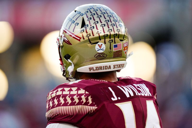 Dec 29, 2022; Orlando, Florida, USA; A detail view of the helmet worn by Florida State Seminoles wide receiver Johnny Wilson (14) as he warms up prior to a game against the Oklahoma Sooners in the 2022 Cheez-It Bowl at Camping World Stadium. Mandatory Credit: Rich Storry-USA TODAY Sports