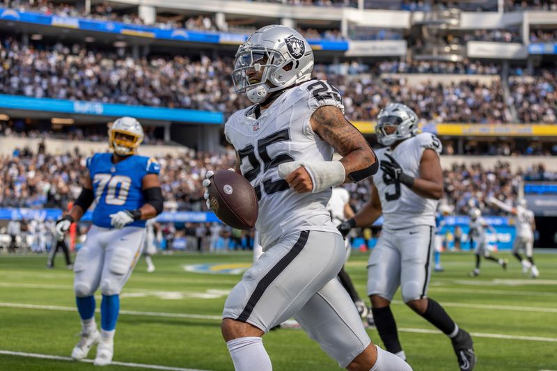 Las Vegas Raiders safety Tre'von Moehrig (25) intercepts a pass against the Los Angeles Chargers in an NFL football game, Sunday, Oct. 1, 2023, in Inglewood, Calif. Chargers won 24-17. (AP Photo/Jeff Lewis)