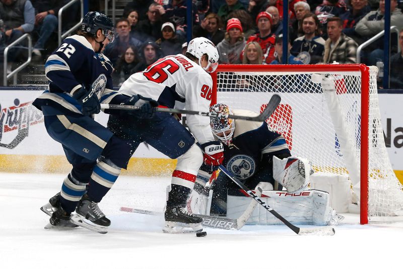 Dec 21, 2023; Columbus, Ohio, USA; Washington Capitals right wing Nicolas Aube-Kubel (96) looks for the rebound of a Columbus Blue Jackets goalie Elvis Merzlikins (90) save during the second period at Nationwide Arena. Mandatory Credit: Russell LaBounty-USA TODAY Sports