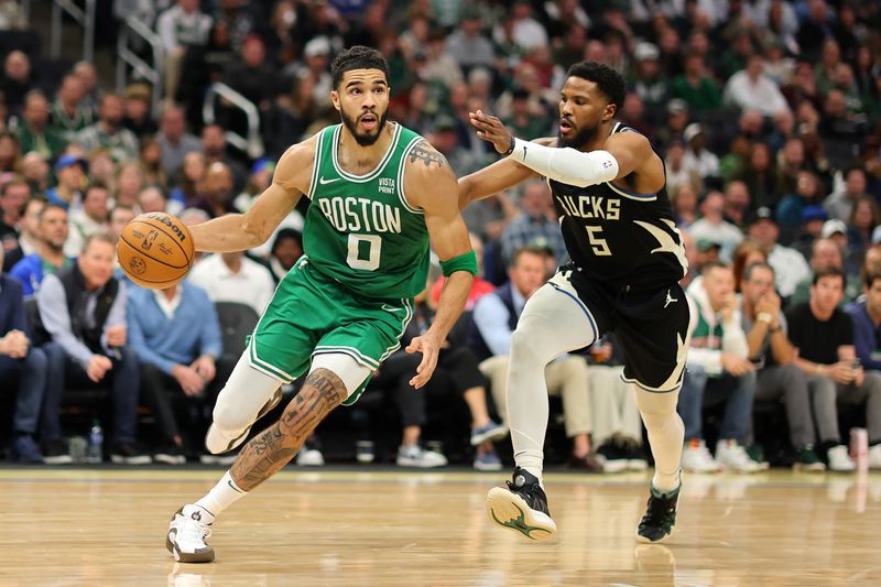 MILWAUKEE, WISCONSIN - APRIL 09: Jayson Tatum #0 of the Boston Celtics drives around Malik Beasley #5 of the Milwaukee Bucks during the second half of a game at Fiserv Forum on April 09, 2024 in Milwaukee, Wisconsin. NOTE TO USER: User expressly acknowledges and agrees that, by downloading and or using this photograph, User is consenting to the terms and conditions of the Getty Images License Agreement. (Photo by Stacy Revere/Getty Images)