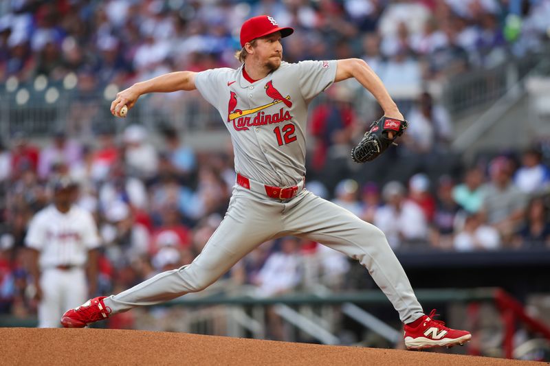 Apr 21, 2025; Atlanta, Georgia, USA; St. Louis Cardinals starting pitcher Erick Fedde (12) throws against the Atlanta Braves in the first inning at Truist Park. Mandatory Credit: Brett Davis-Imagn Images