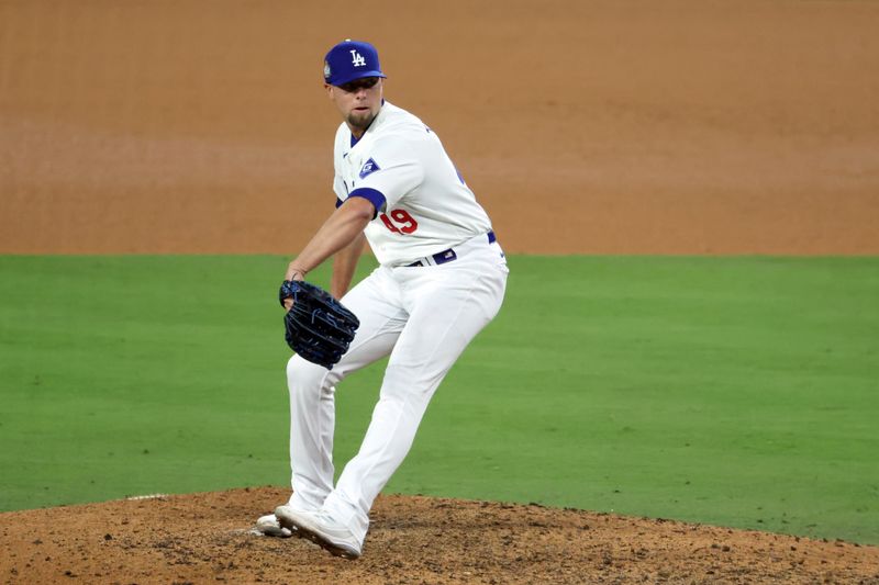 Oct 25, 2024; Los Angeles, California, USA; Los Angeles Dodgers pitcher Blake Treinen (49) pitches in the ninth inning against the New York Yankees during game one of the 2024 MLB World Series at Dodger Stadium. Mandatory Credit: Kiyoshi Mio-Imagn Images