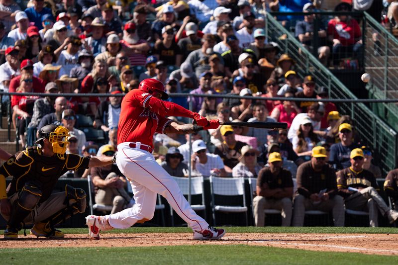 Mar 10, 2024; Tempe, Arizona, USA; Los Angeles Angels outfielder Aaron Hicks (12) doubles on a line drive to right in the sixth during a spring training game against the San Diego Padres at Tempe Diablo Stadium. Mandatory Credit: Allan Henry-USA TODAY Sports