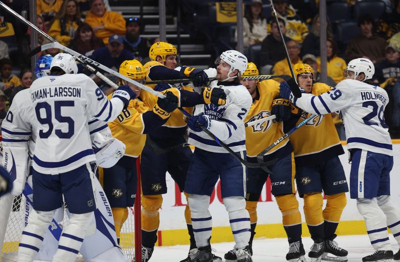 Mar 22, 2025; Nashville, Tennessee, USA; Toronto Maple Leafs and Nashville Predators players scuffle during the first period of their game at Bridgestone Arena. Mandatory Credit: Alan Poizner-Imagn Images