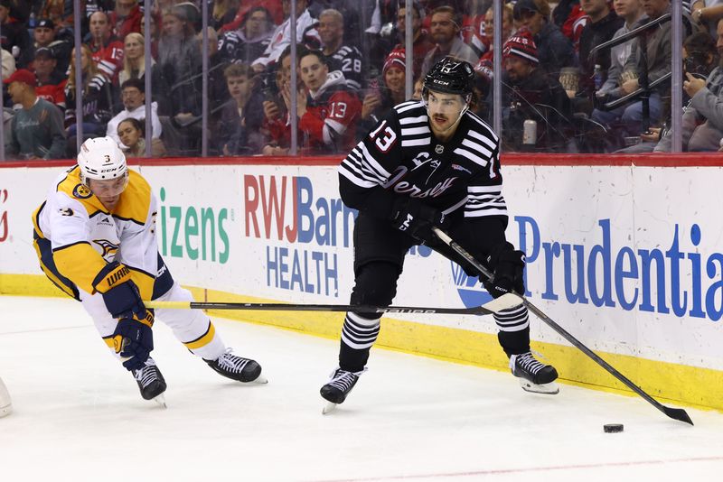 Nov 25, 2024; Newark, New Jersey, USA; New Jersey Devils center Nico Hischier (13) plays the puck while being defended by Nashville Predators defenseman Jeremy Lauzon (3) during the second period at Prudential Center. Mandatory Credit: Ed Mulholland-Imagn Images