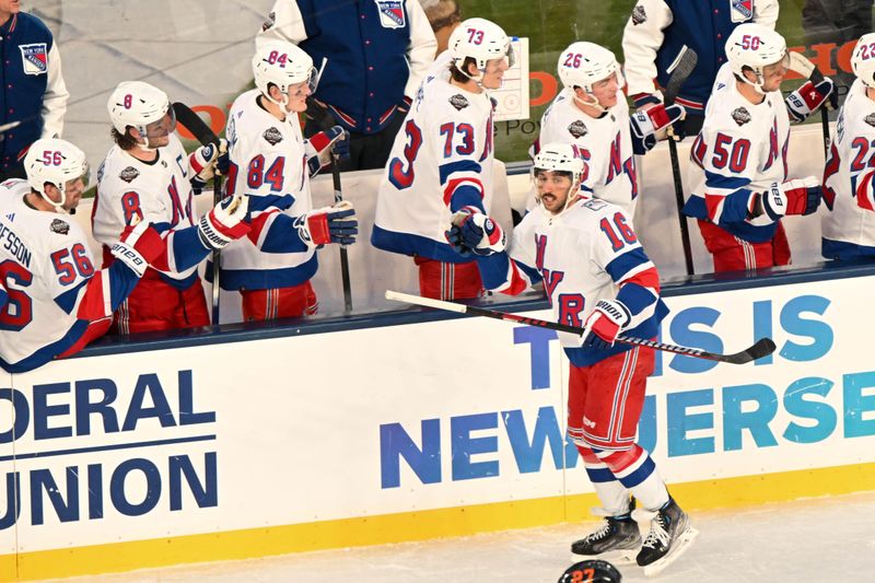 Feb 18, 2024; East Rutherford, New Jersey, USA;  New York Rangers center Vincent Trocheck (16) celebrates celebrates his goal against the New York Islanders during the second period in a Stadium Series ice hockey game at MetLife Stadium. Mandatory Credit: Dennis Schneidler-USA TODAY Sports