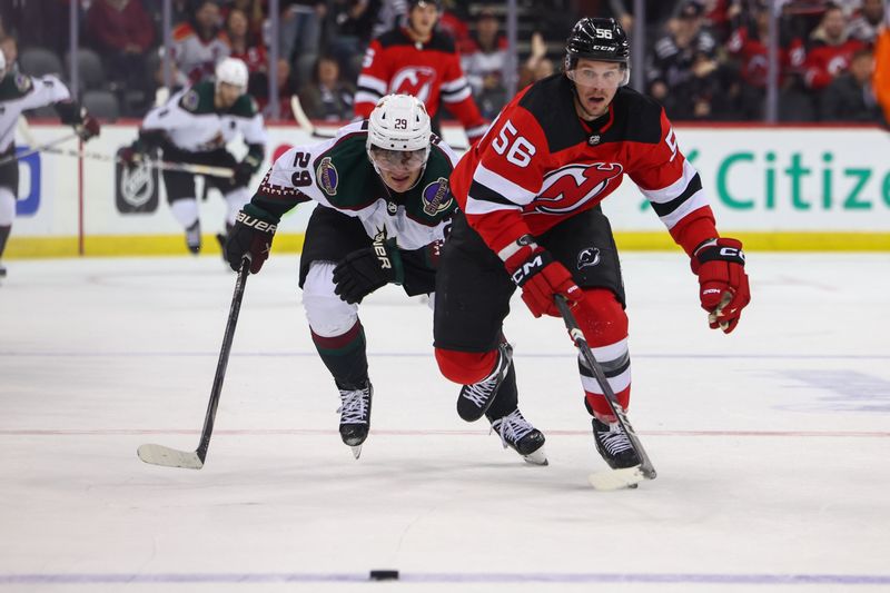 Oct 13, 2023; Newark, New Jersey, USA; New Jersey Devils left wing Erik Haula (56) and Arizona Coyotes center Barrett Hayton (29) race for the puck during overtime at Prudential Center. Mandatory Credit: Ed Mulholland-USA TODAY Sports