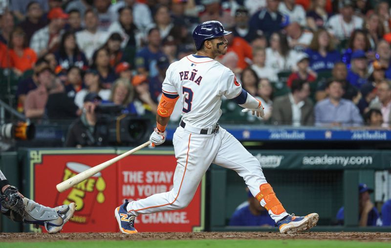 Apr 3, 2024; Houston, Texas, USA; Houston Astros shortstop Jeremy Pena (3) hits a home run during the seventh inning against the Toronto Blue Jays at Minute Maid Park. Mandatory Credit: Troy Taormina-USA TODAY Sports