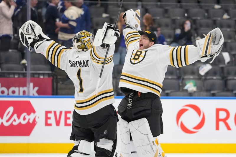 Apr 24, 2024; Toronto, Ontario, CAN; Boston Bruins goaltender Linus Ullmark (right) congratulates goaltender Jeremy Swayman (1) on a win over the Toronto Maple Leafs in game three of the first round of the 2024 Stanley Cup Playoffs at Scotiabank Arena. Mandatory Credit: John E. Sokolowski-USA TODAY Sports