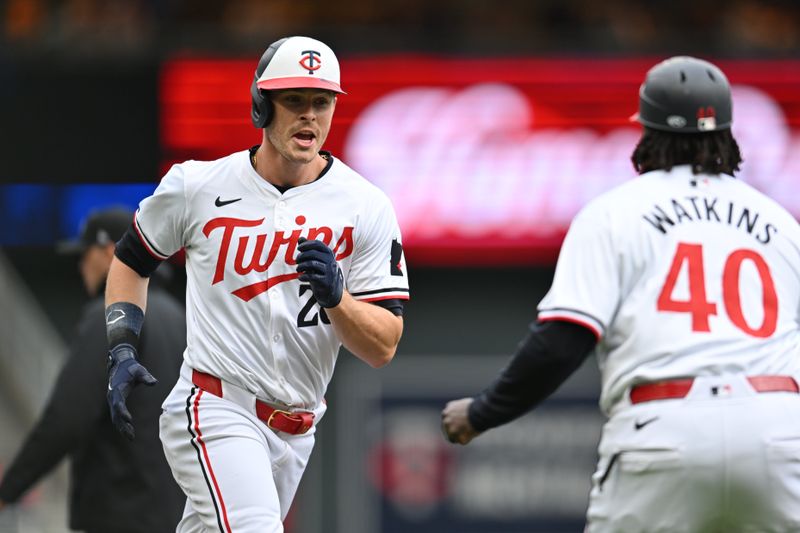 May 4, 2024; Minneapolis, Minnesota, USA; Minnesota Twins outfielder Max Kepler (26) reacts with third base coach Tommy Watkins (40) after hitting a home run during the fourth inning against the Boston Red Sox at Target Field. Mandatory Credit: Jeffrey Becker-USA TODAY Sports