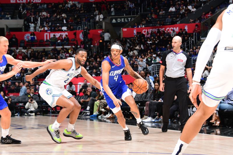 LOS ANGELES, CA - MARCH 12:  Brandon Boston Jr. #4 of the LA Clippers handles the ball during the game against the Minnesota Timberwolves on March 12, 2024 at Crypto.Com Arena in Los Angeles, California. NOTE TO USER: User expressly acknowledges and agrees that, by downloading and/or using this Photograph, user is consenting to the terms and conditions of the Getty Images License Agreement. Mandatory Copyright Notice: Copyright 2024 NBAE (Photo by Tyler Ross/NBAE via Getty Images)