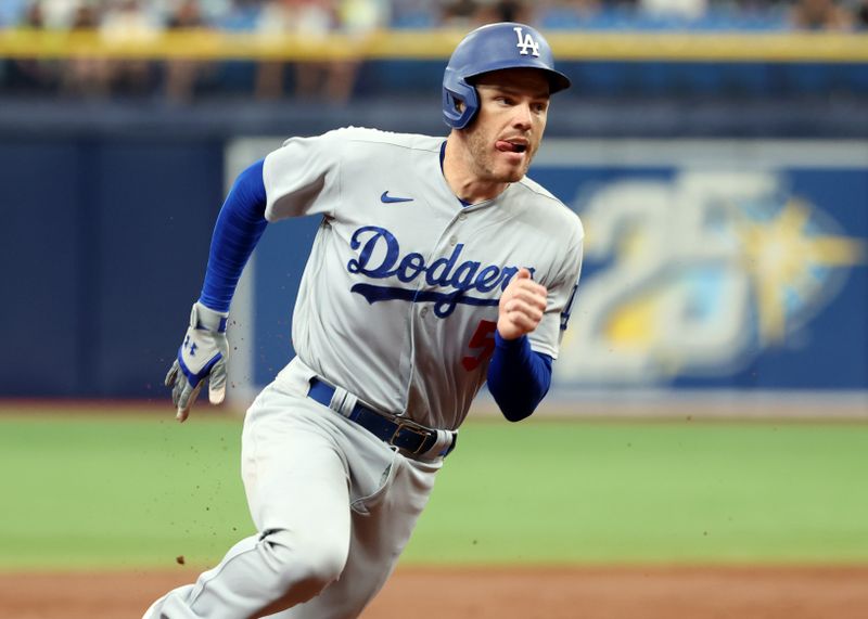 May 28, 2023; St. Petersburg, Florida, USA; Los Angeles Dodgers first baseman Freddie Freeman (5) runs home to score a run during the third inning against the Tampa Bay Rays at Tropicana Field. Mandatory Credit: Kim Klement-USA TODAY Sports