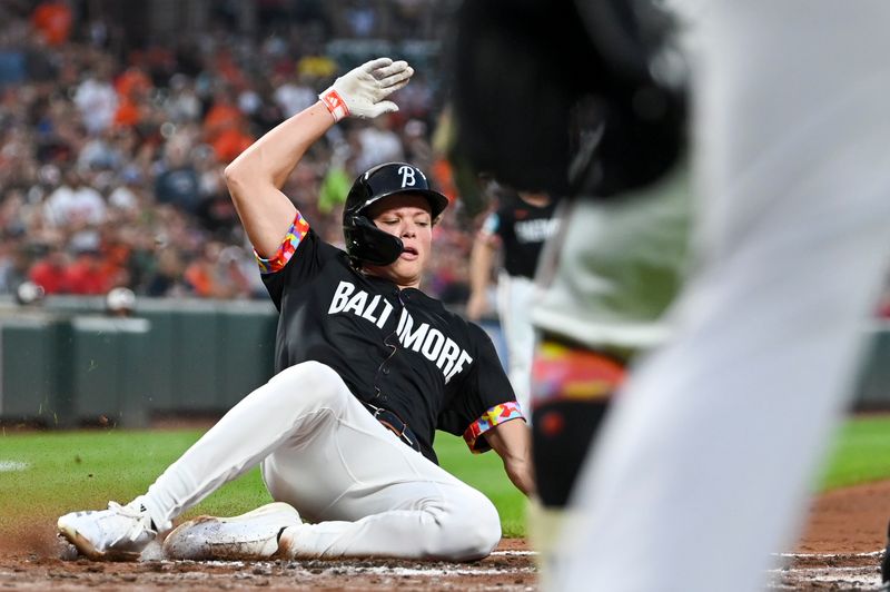 Aug 16, 2024; Baltimore, Maryland, USA;  Baltimore Orioles second baseman Jackson Holliday (7) slides to score on third baseman Ramon Urias (not pictured) rbi single against the Boston Red Sox at Oriole Park at Camden Yards. Mandatory Credit: Tommy Gilligan-USA TODAY Sports