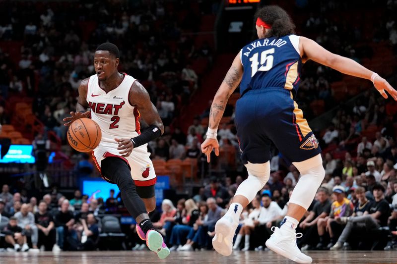 MIAMI, FLORIDA - MARCH 22: Terry Rozier #2 of the Miami Heat dribbles the ball against Jose Alvarado #15 of the New Orleans Pelicans during the first quarter at Kaseya Center on March 22, 2024 in Miami, Florida. NOTE TO USER: User expressly acknowledges and agrees that, by downloading and or using this photograph, User is consenting to the terms and conditions of the Getty Images License Agreement. (Photo by Rich Storry/Getty Images)