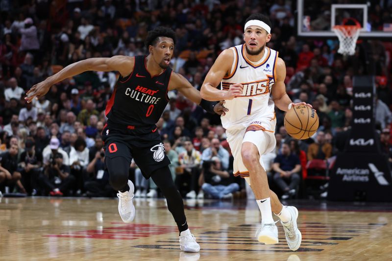 MIAMI, FLORIDA - JANUARY 29: Devin Booker #1 of the Phoenix Suns drives against Josh Richardson #0 of the Miami Heat during the second quarter of the game at Kaseya Center on January 29, 2024 in Miami, Florida. NOTE TO USER: User expressly acknowledges and agrees that, by downloading and or using this photograph, User is consenting to the terms and conditions of the Getty Images License Agreement. (Photo by Megan Briggs/Getty Images)