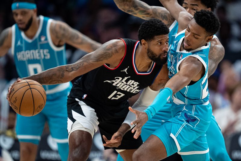 CHARLOTTE, NORTH CAROLINA - MARCH 31: Brandon Miller #24 of the Charlotte Hornets guards Paul George #13 of the LA Clippers in the third quarter during their game at Spectrum Center on March 31, 2024 in Charlotte, North Carolina. NOTE TO USER: User expressly acknowledges and agrees that, by downloading and or using this photograph, User is consenting to the terms and conditions of the Getty Images License Agreement. (Photo by Jacob Kupferman/Getty Images)