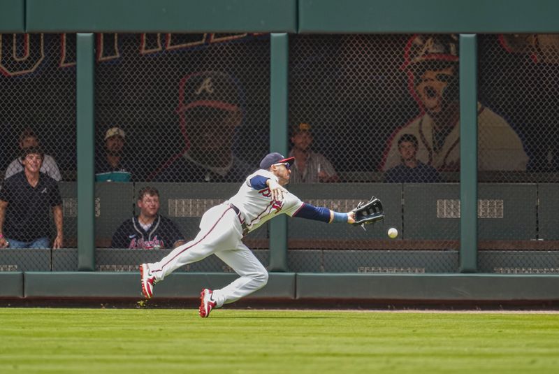 Jul 24, 2024; Cumberland, Georgia, USA; Atlanta Braves right fielder Adam Duvall (14) can not catch a ball hit by Cincinnati Reds first baseman Spencer Steer (7) (not pictured) during the first inning at Truist Park. Mandatory Credit: Dale Zanine-USA TODAY Sports