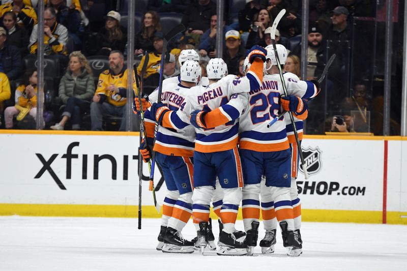 Jan 13, 2024; Nashville, Tennessee, USA; New York Islanders players celebrate after a goal by New York Islanders center Jean-Gabriel Pageau (44) during the third period against the Nashville Predators at Bridgestone Arena. Mandatory Credit: Christopher Hanewinckel-USA TODAY Sports