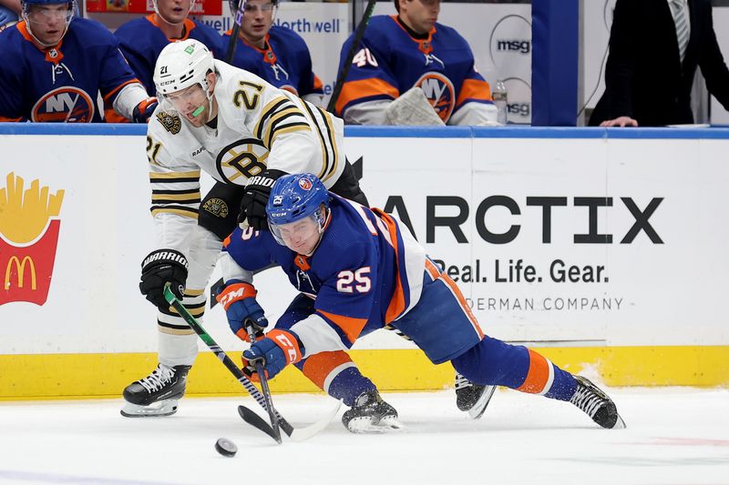 Mar 2, 2024; Elmont, New York, USA; Boston Bruins left wing James van Riemsdyk (21) and New York Islanders defenseman Sebastian Aho (25) fight for the puck during the first period at UBS Arena. Mandatory Credit: Brad Penner-USA TODAY Sports