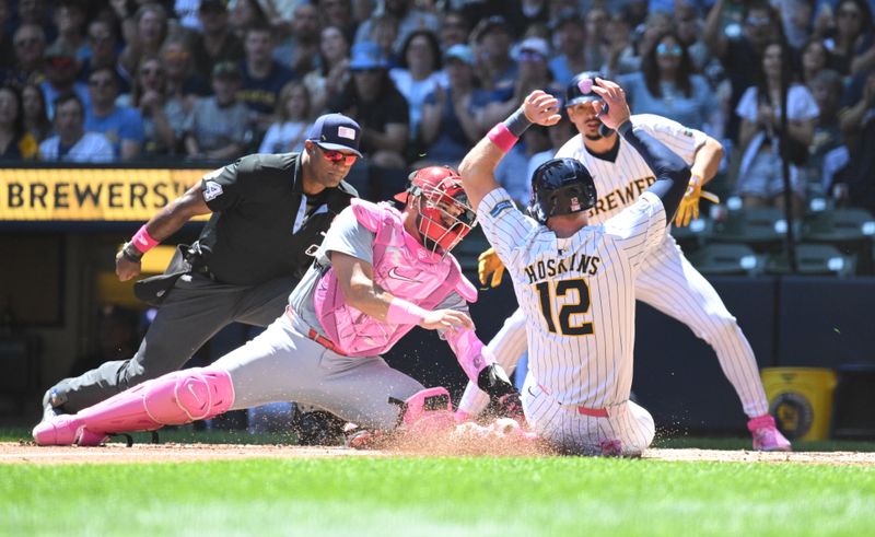 May 12, 2024; Milwaukee, Wisconsin, USA; St. Louis Cardinals catcher Iván Herrera (48) tags out Milwaukee Brewers first base Rhys Hoskins (12) on a base hit in the first inning at American Family Field. Mandatory Credit: Michael McLoone-USA TODAY Sports